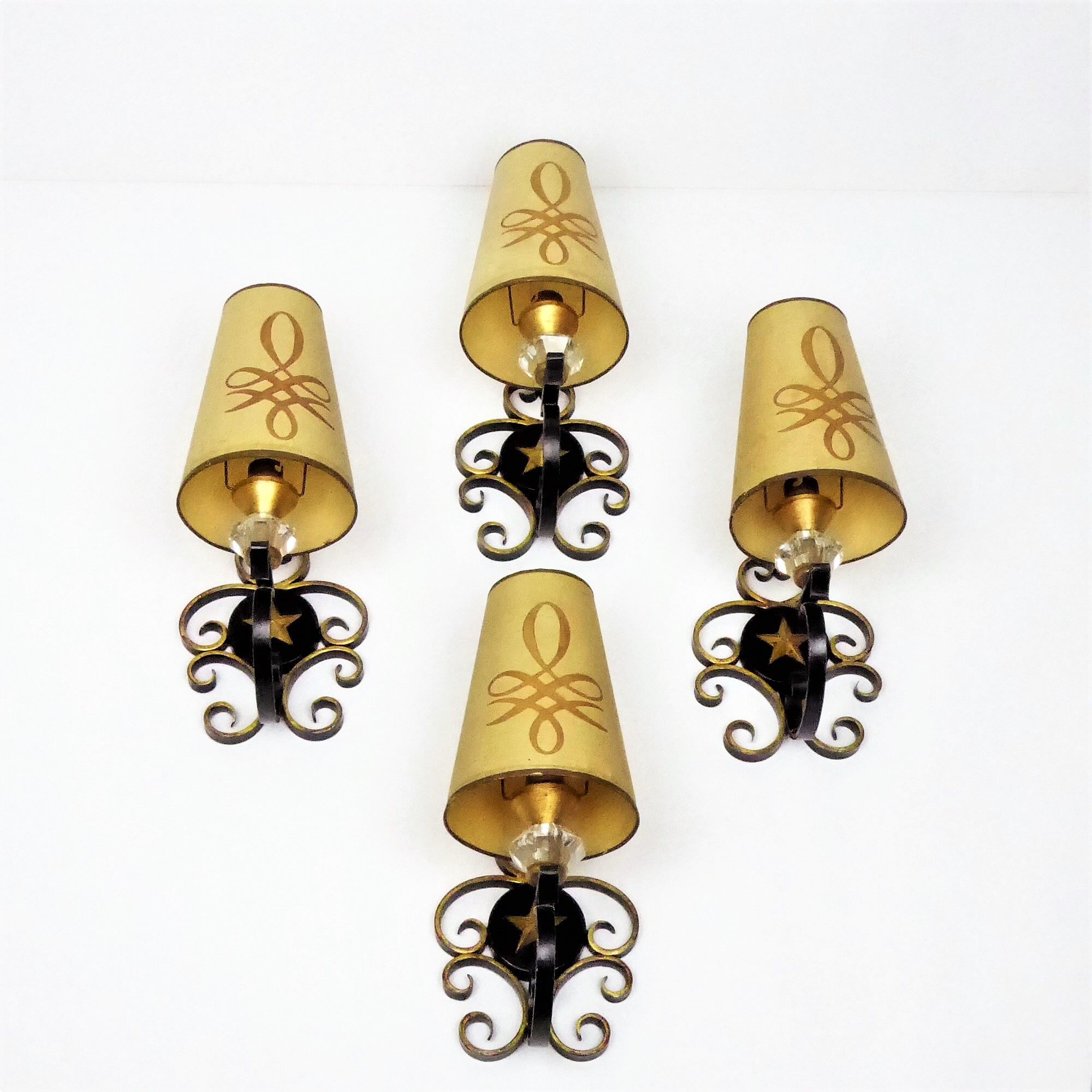 1950 gold star and black metal sconces