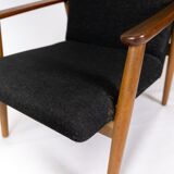 Easy chair with stool in teak and dark wool fabric of danish design from the 1960s.