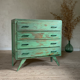Vintage compass leg commode with a patina.