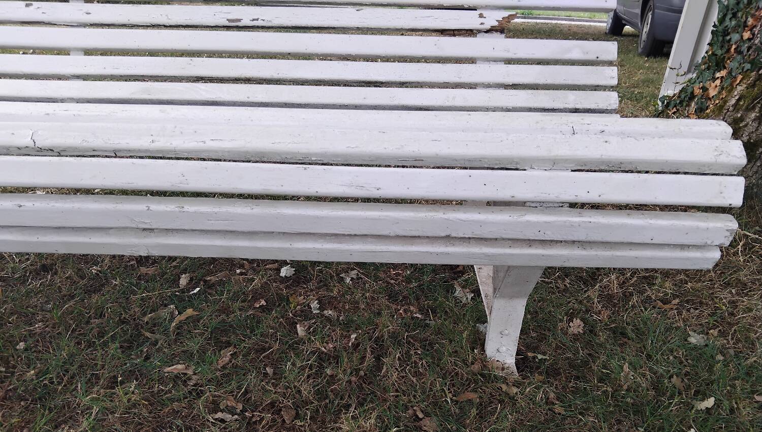 Old garden bench with metal legs and wooden slats