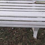 Old garden bench with metal legs and wooden slats