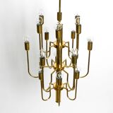 Three staged 18 arm Mid Century brass chandelier with a long brass rod