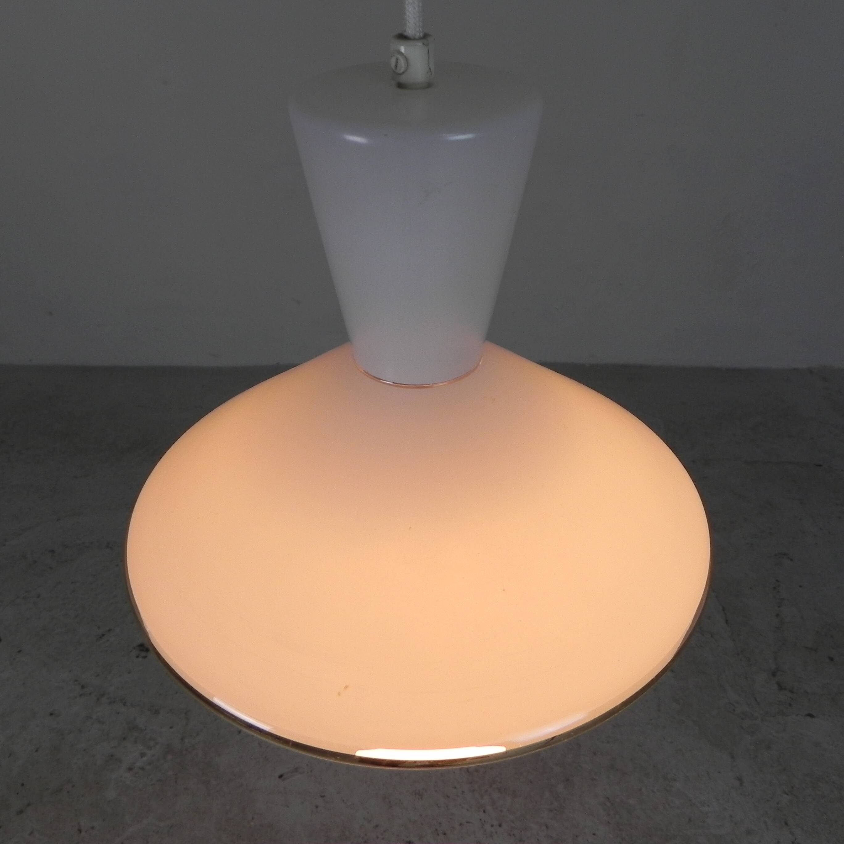 UFO-shaped pendant lamp with white glass on top and clear glass with white