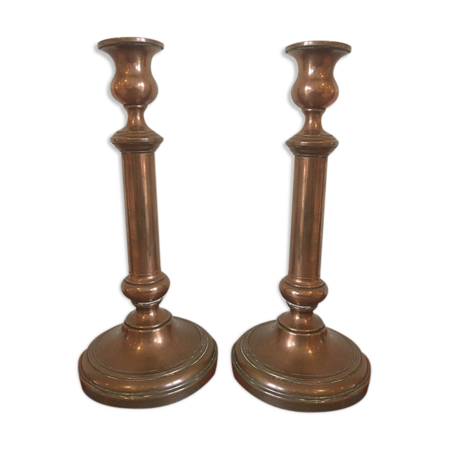 Pair of red brass candlesticks