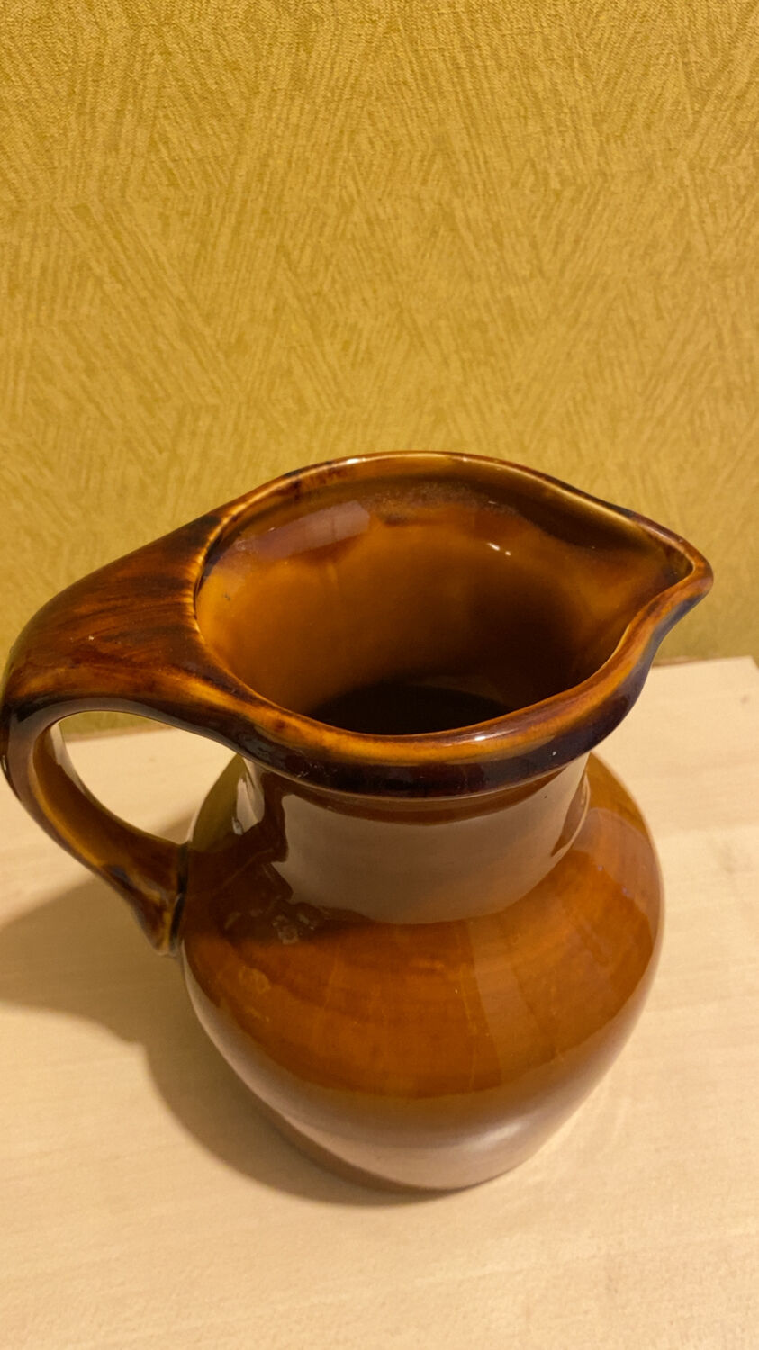 St. Clement brown ceramic pitcher, 1970