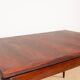 Danish extendable dining table in rosewood and brass by Poul Volther