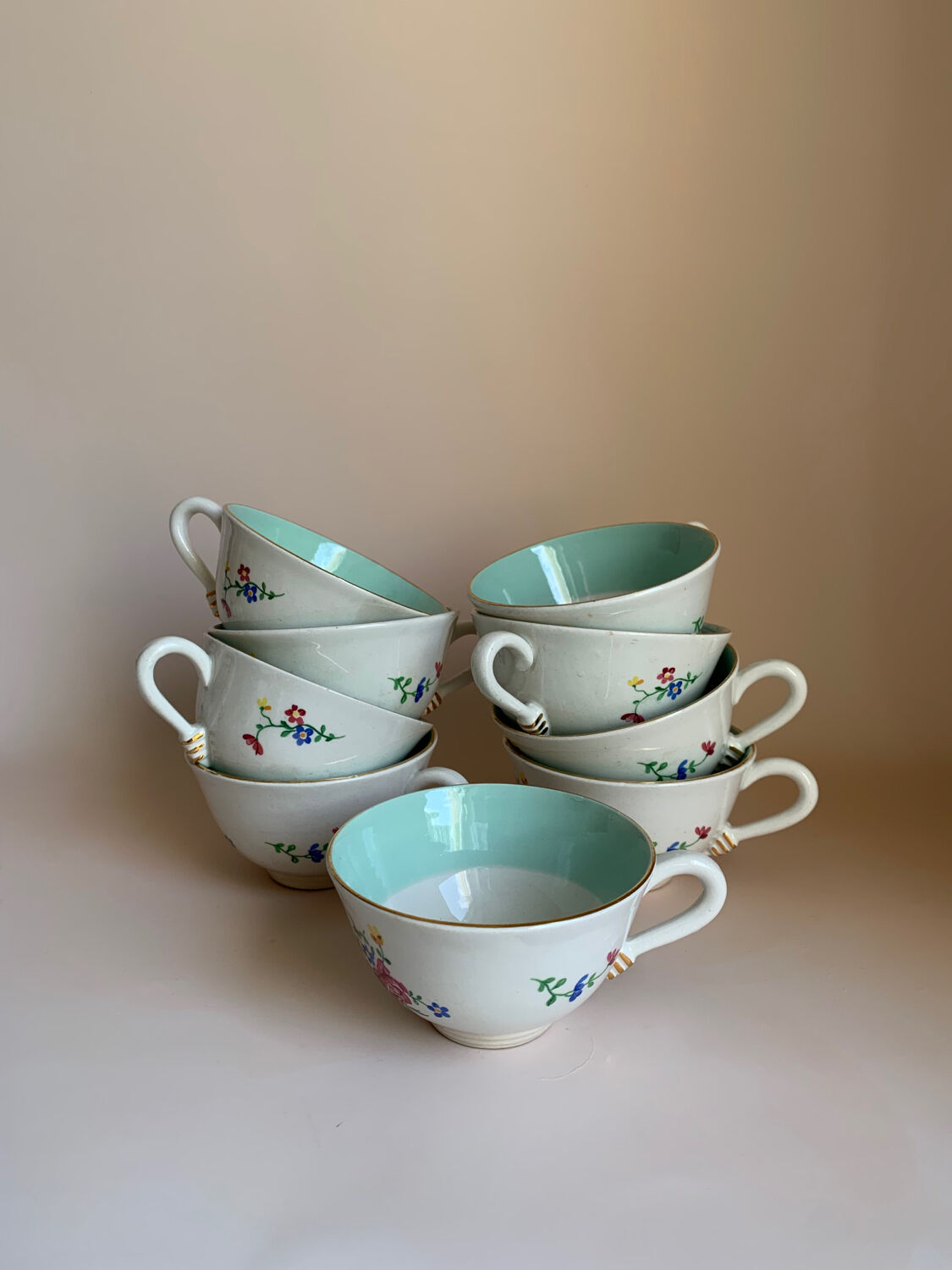 Set of 9 floral Luneville porcelain coffee cups with gold edges