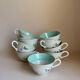 Set of 9 floral Luneville porcelain coffee cups with gold edges