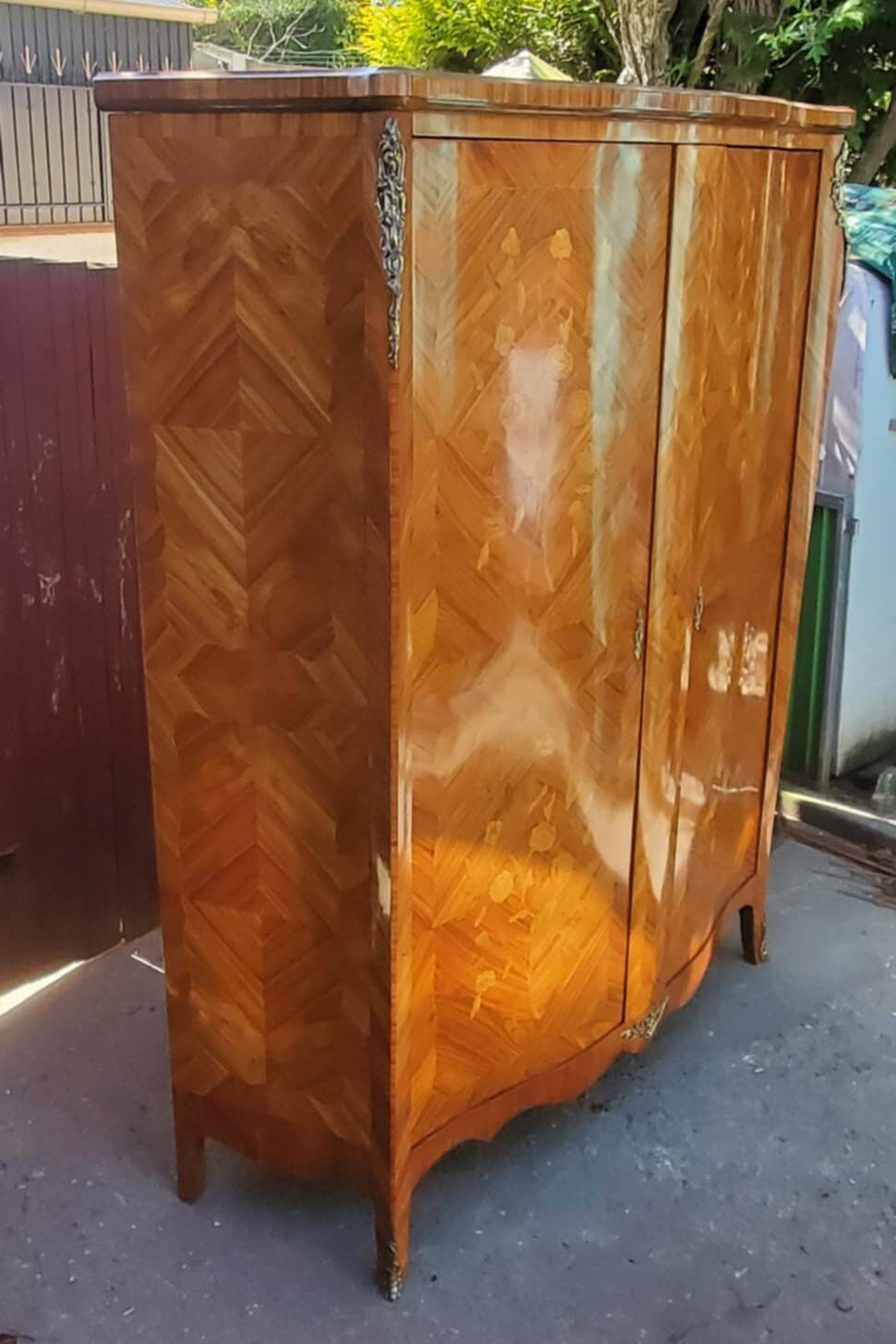 Two-door cabinet with marquetry floral design from the early 20th century.