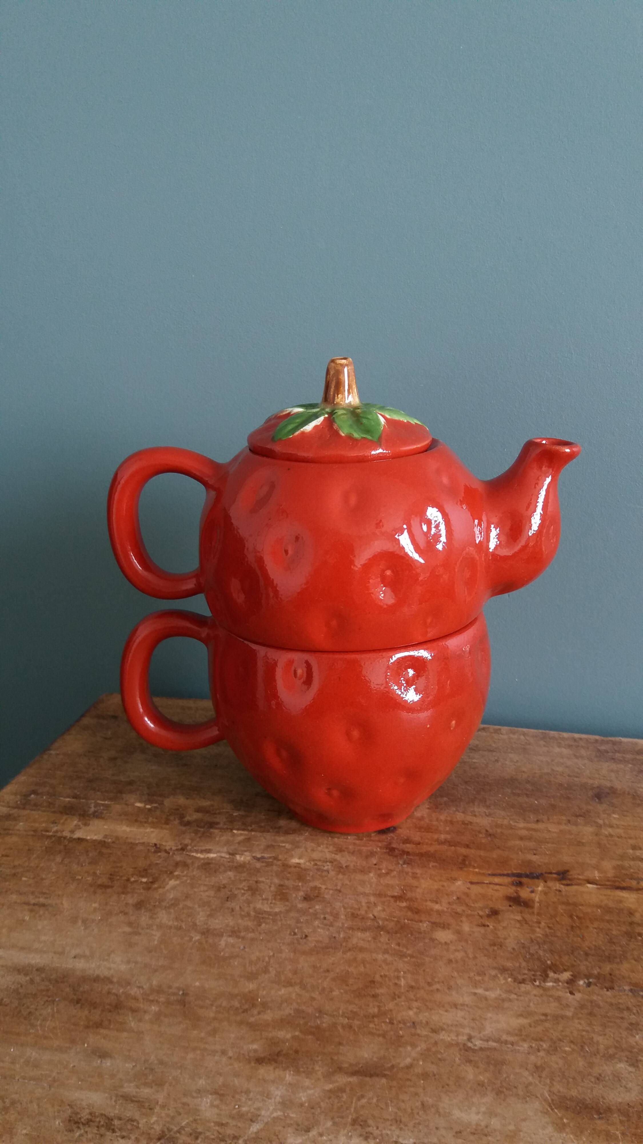 Teapot and cup in the shape of a strawberry.