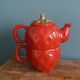 Teapot and cup in the shape of a strawberry.