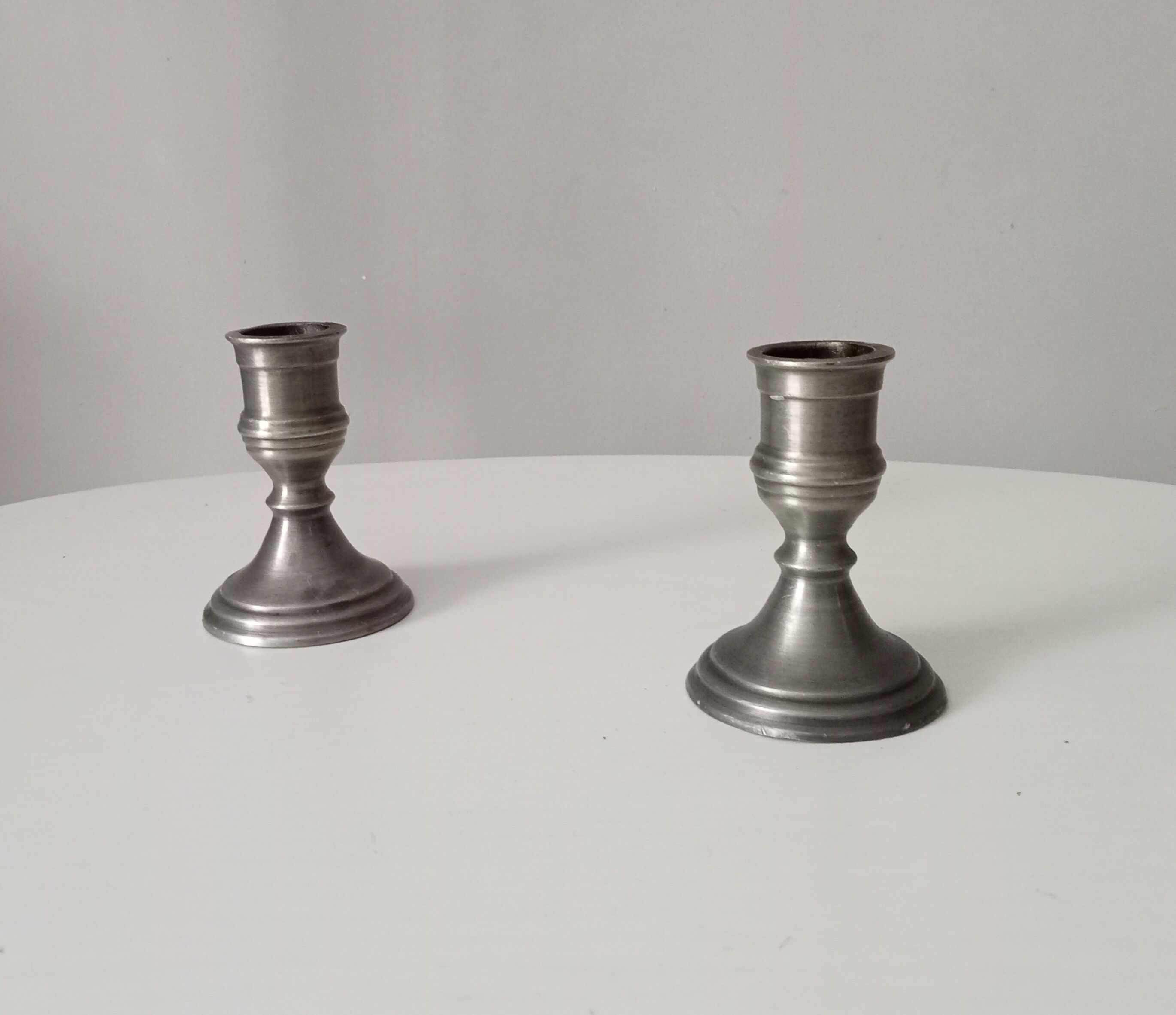 Pair of antique pewter candle holders