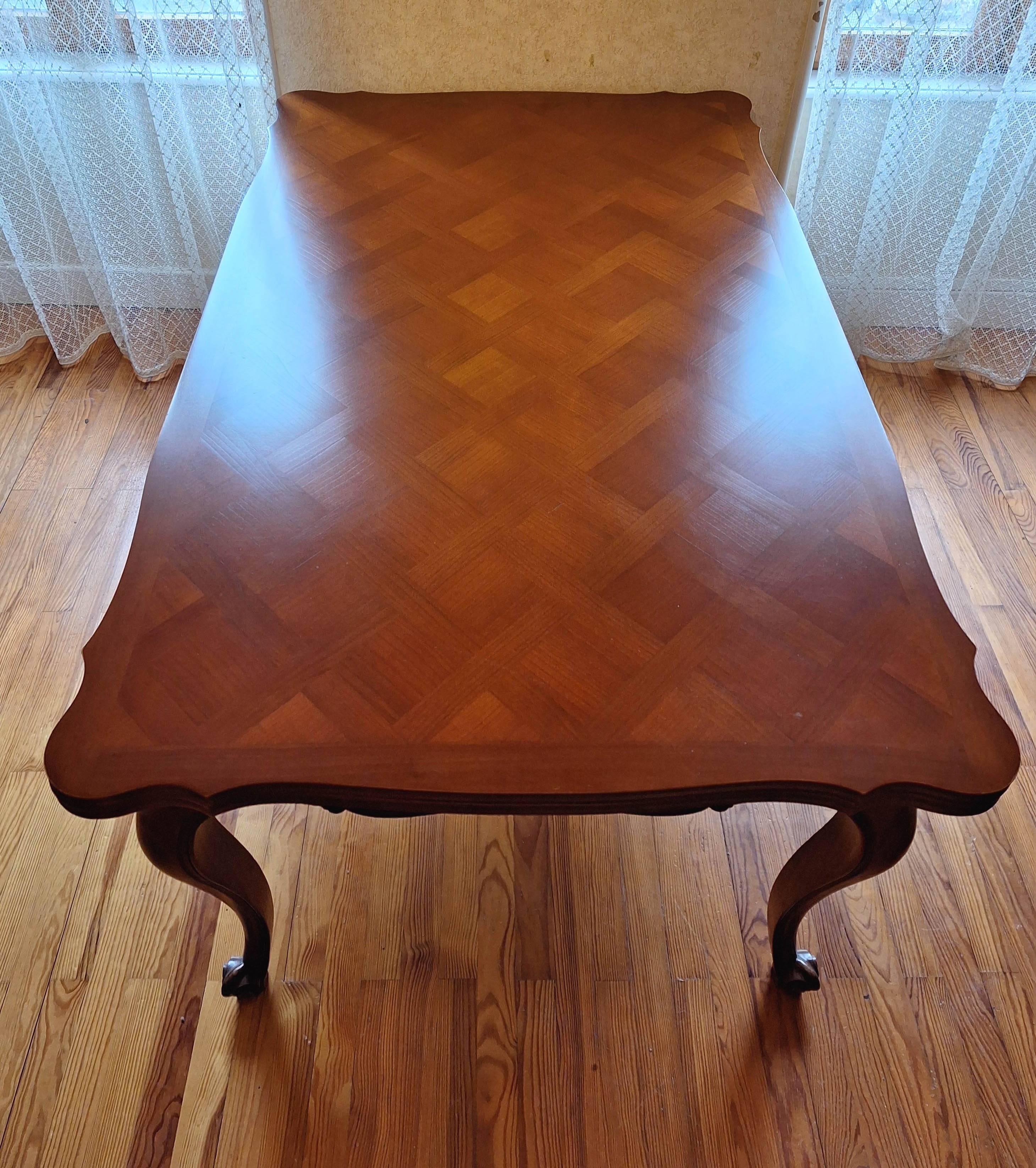 Extendable table in Louis XV style made of solid cherry wood and marquetry.