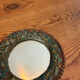 Round mirror in gilded enamelled ceramic with inlay