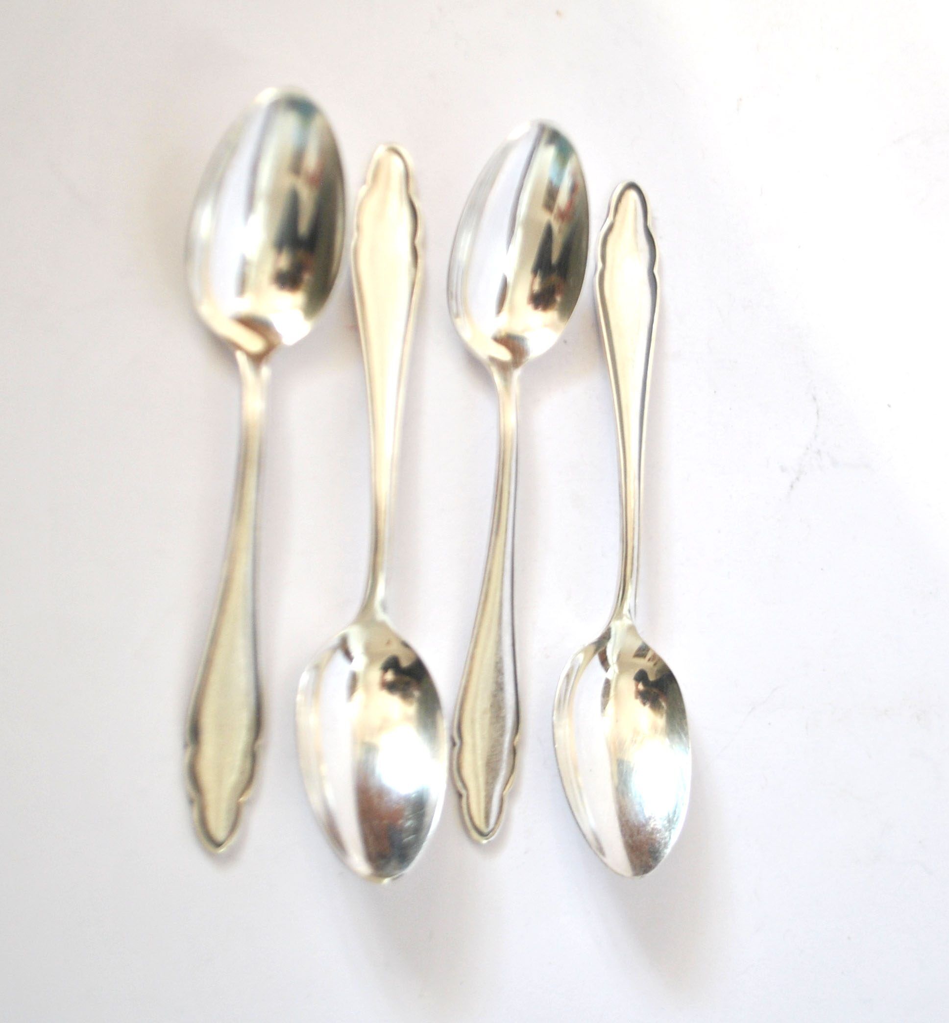 DEETJEN set of 4 silver-plated dessert spoons with a modernist scalloped design.