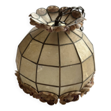 Vintage pendant light with a pearlescent shade and floral decoration.