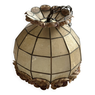 Vintage pendant light with a pearlescent shade and floral decoration.