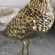 Crested bird in golden brass