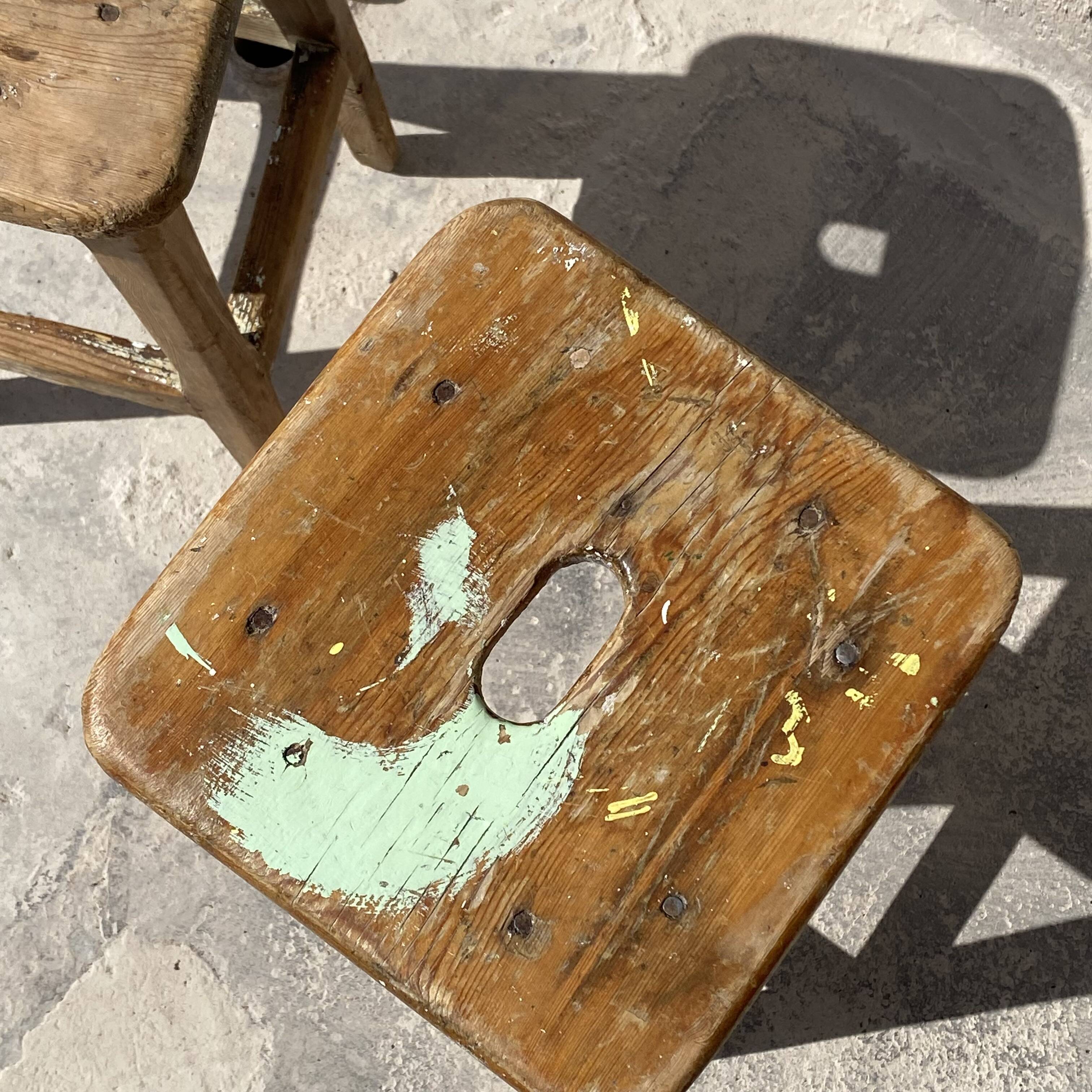 Pair of vintage wooden workshop stools with a patina.