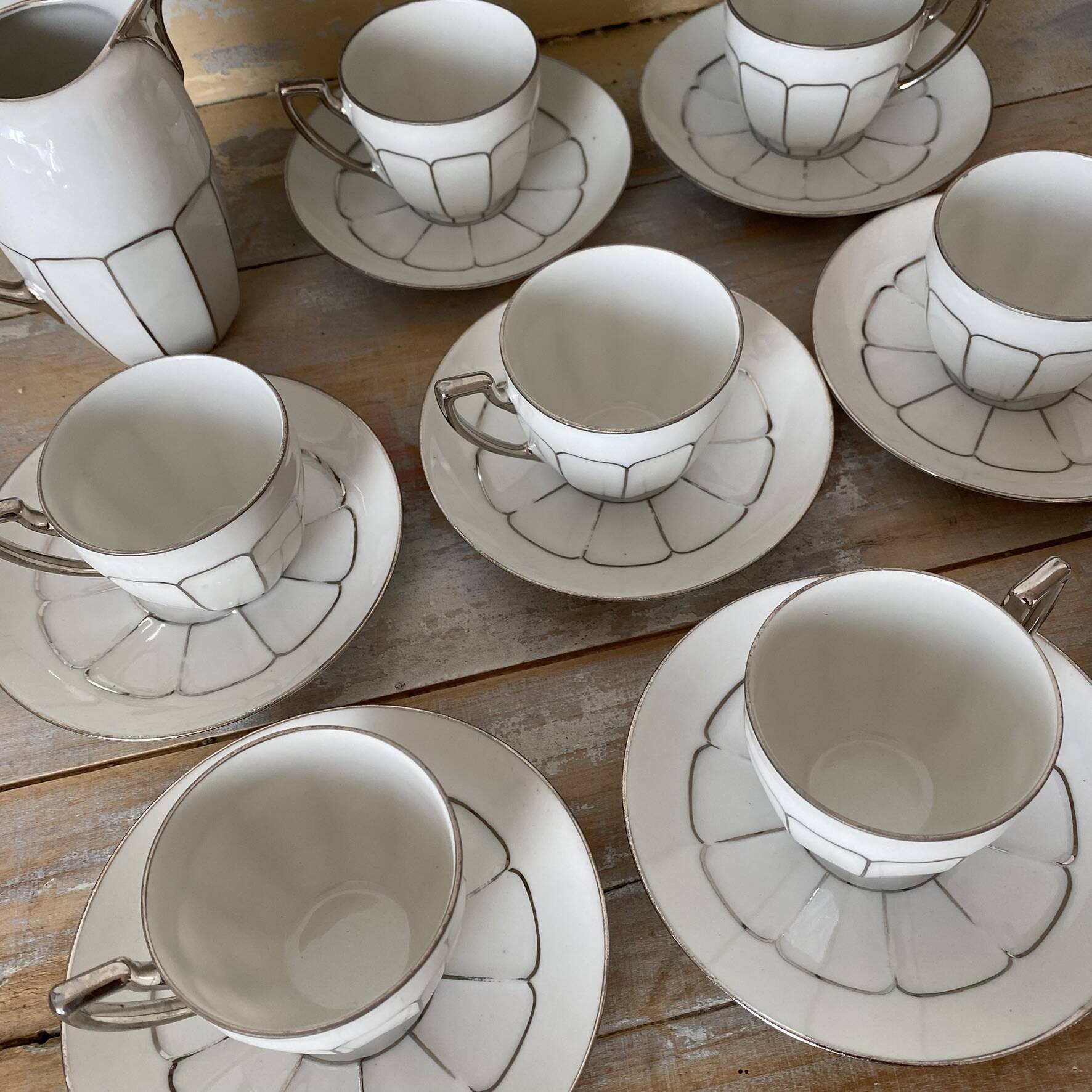 White and silver Limoges porcelain coffee cups and saucers.