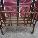 Old small bed or cradle for baby in vintage rattan