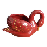Poet Laval swan hides zoomorphic pot in burgundy ceramic.