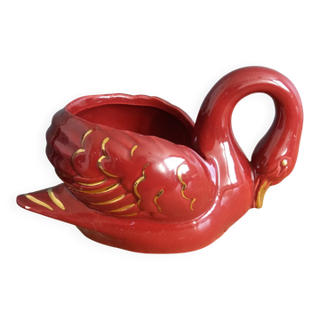 Poet Laval swan hides zoomorphic pot in burgundy ceramic.