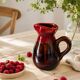 Vintage pitcher in raspberry red and chocolate flamed ceramic.