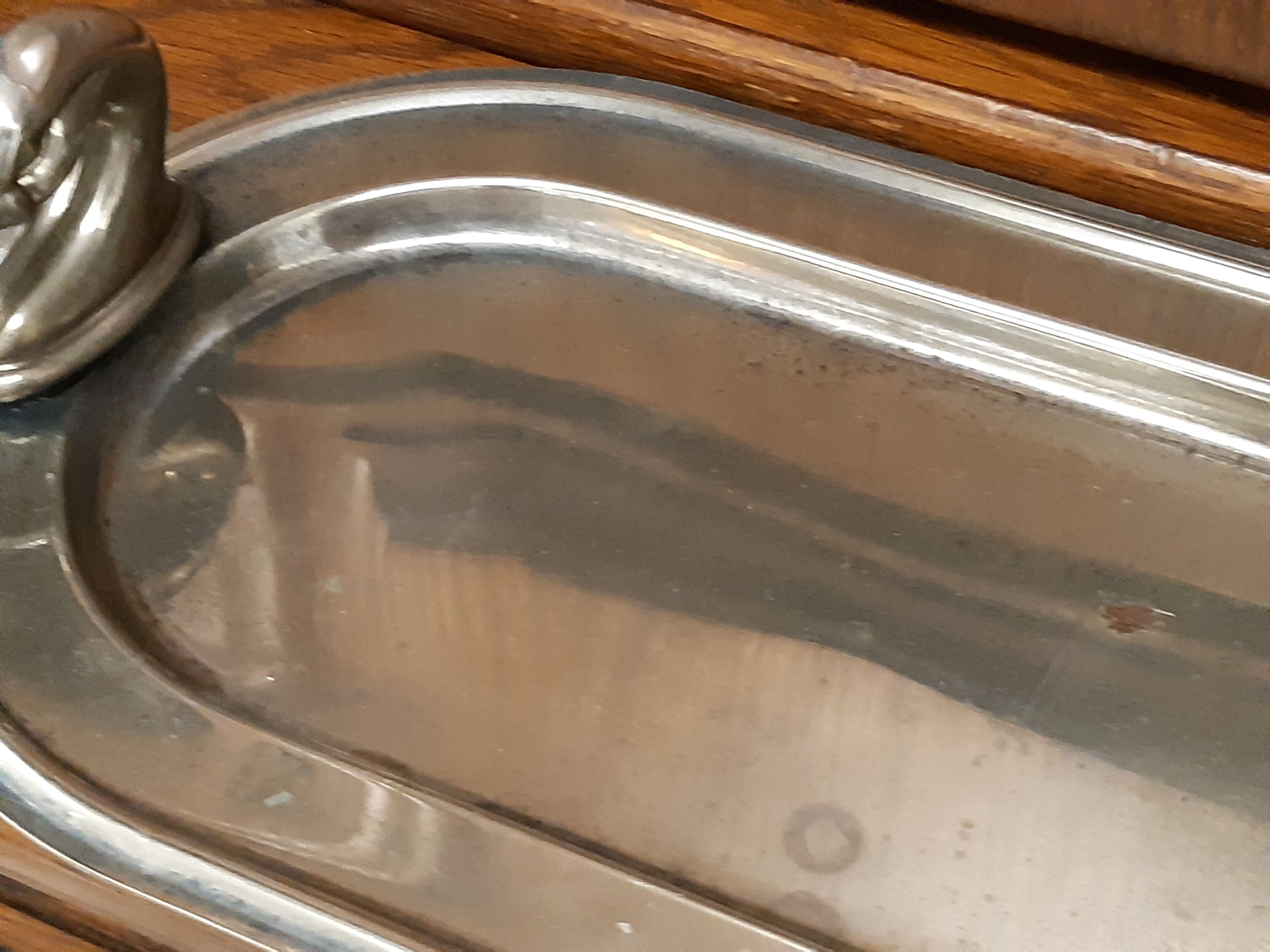 Silver dish with foie gras, duck heads