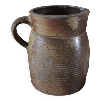 Terracotta jug with a spout handle.