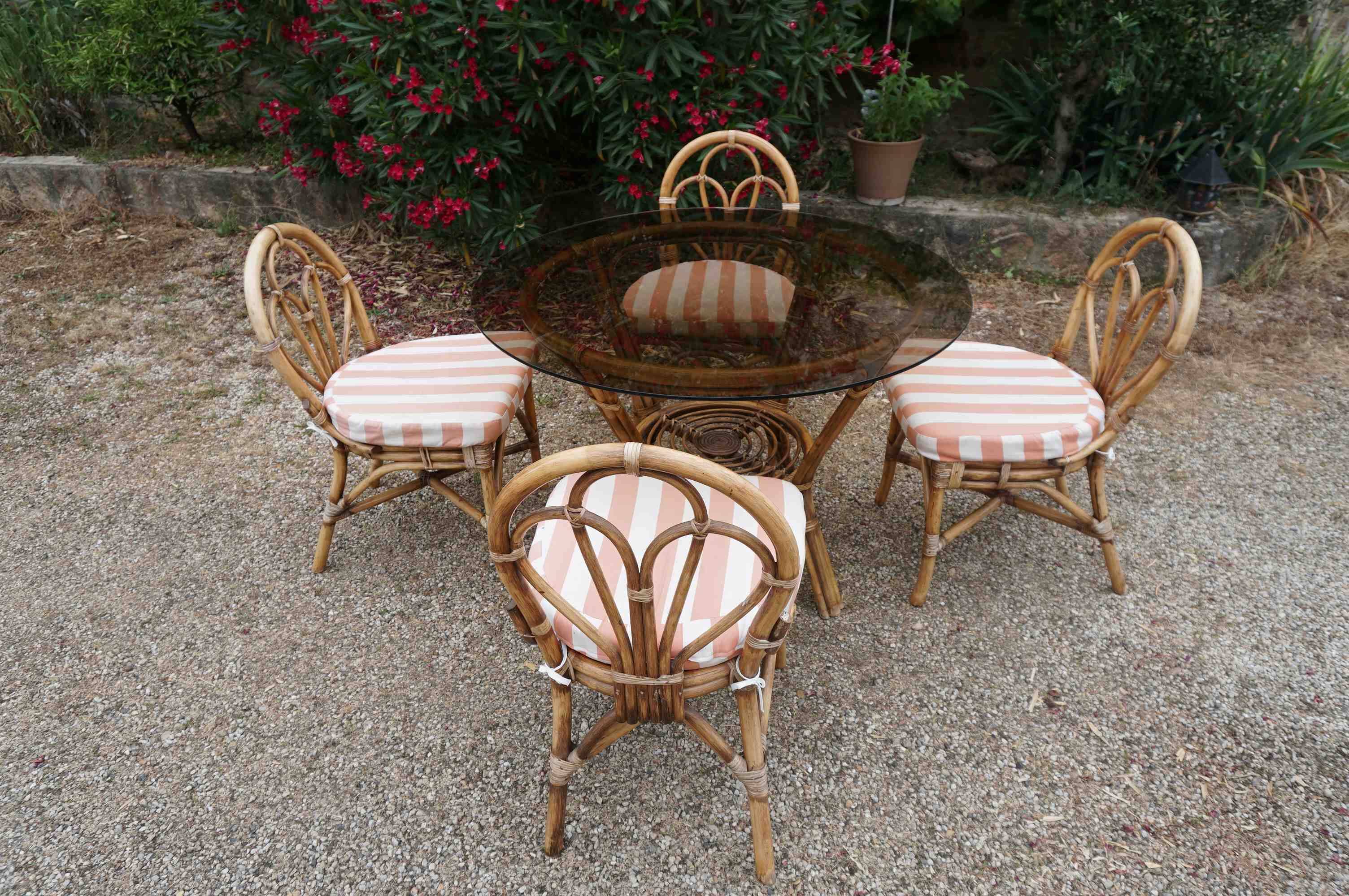 dining table and chairs made of curved bamboo and rattan with smoked glass from the 1970s