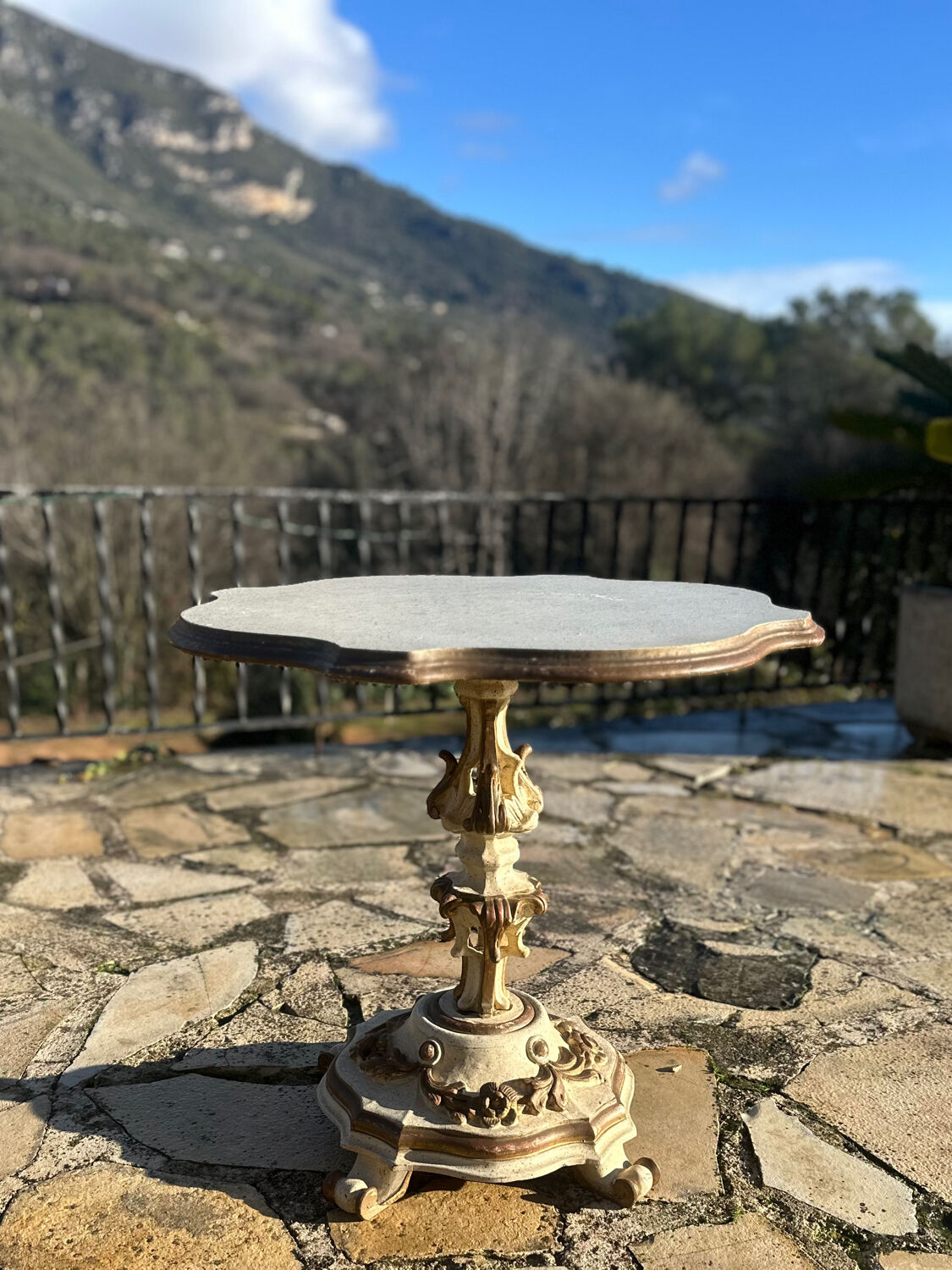 Carved and lacquered wooden side table.