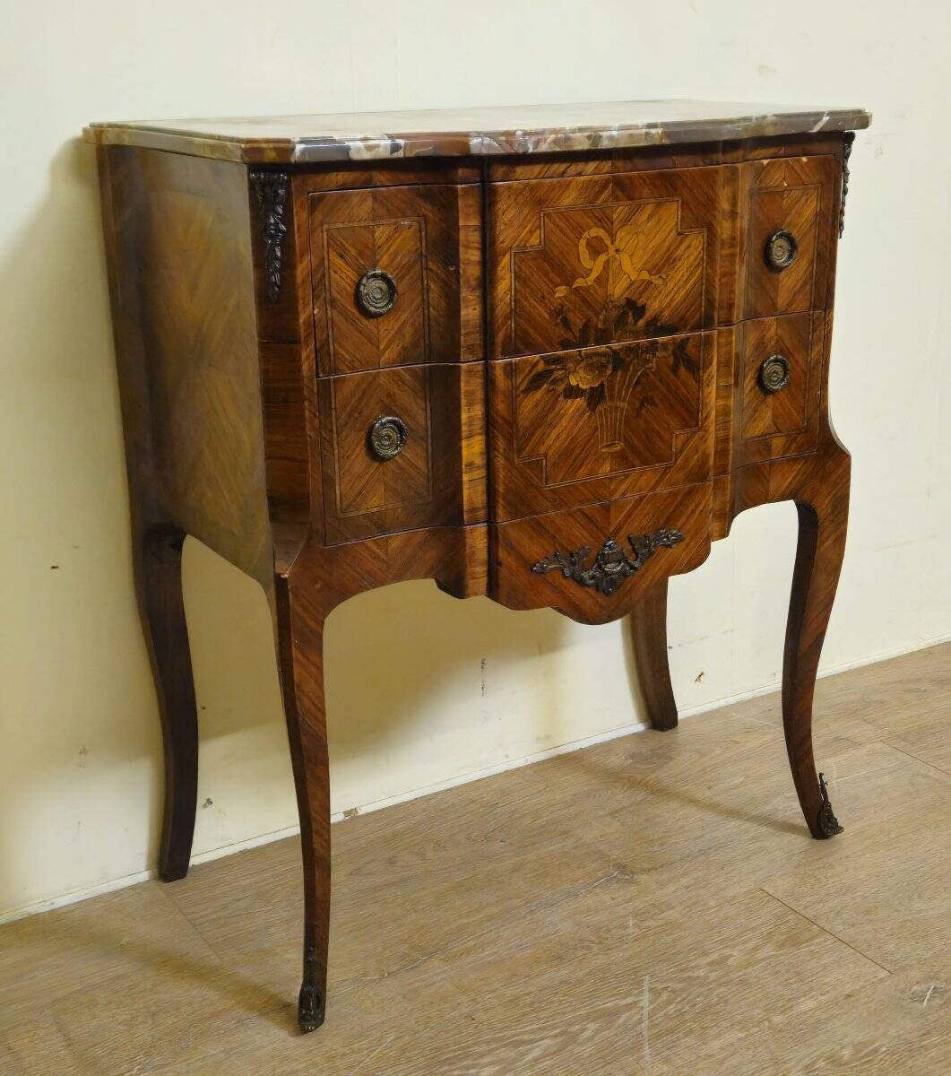 Louis XV style commode with a projection in marquetry.