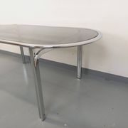 Vintage oval dining table in smoked glass and chrome metal, Space Age style.
