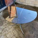 Table with chrome metal legs and smoked glass top.