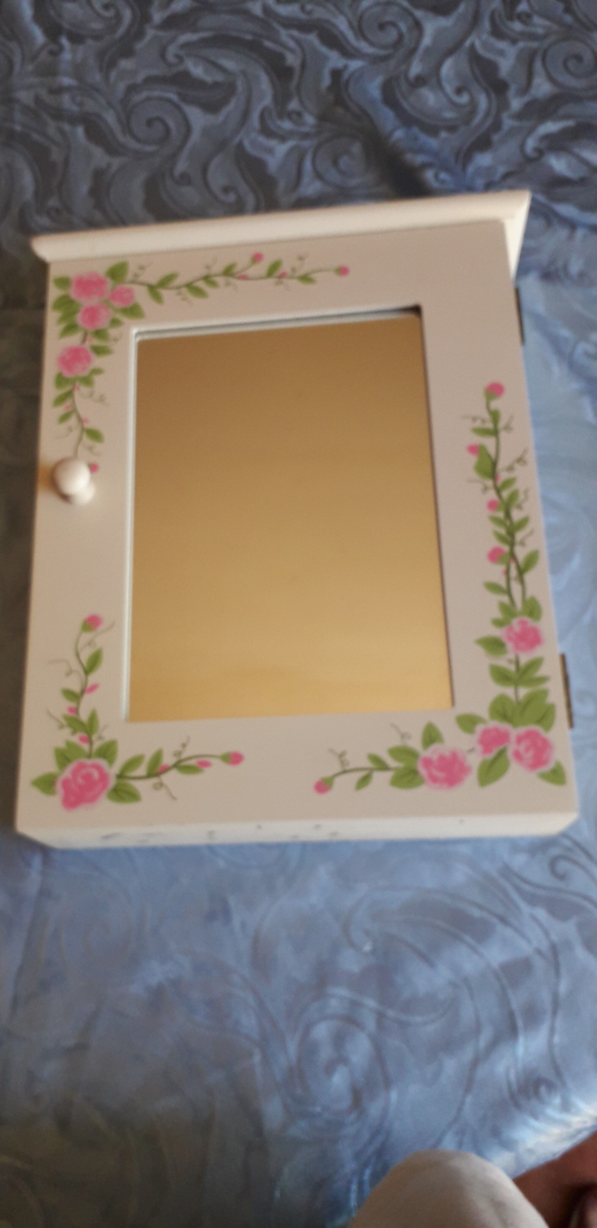 White mirrored toilet cabinet with floral pattern