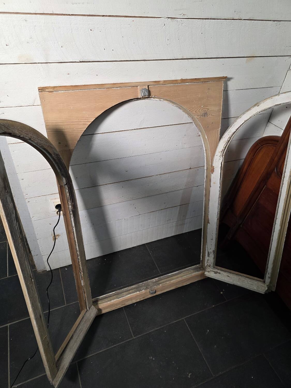 Old arched window made of fir wood