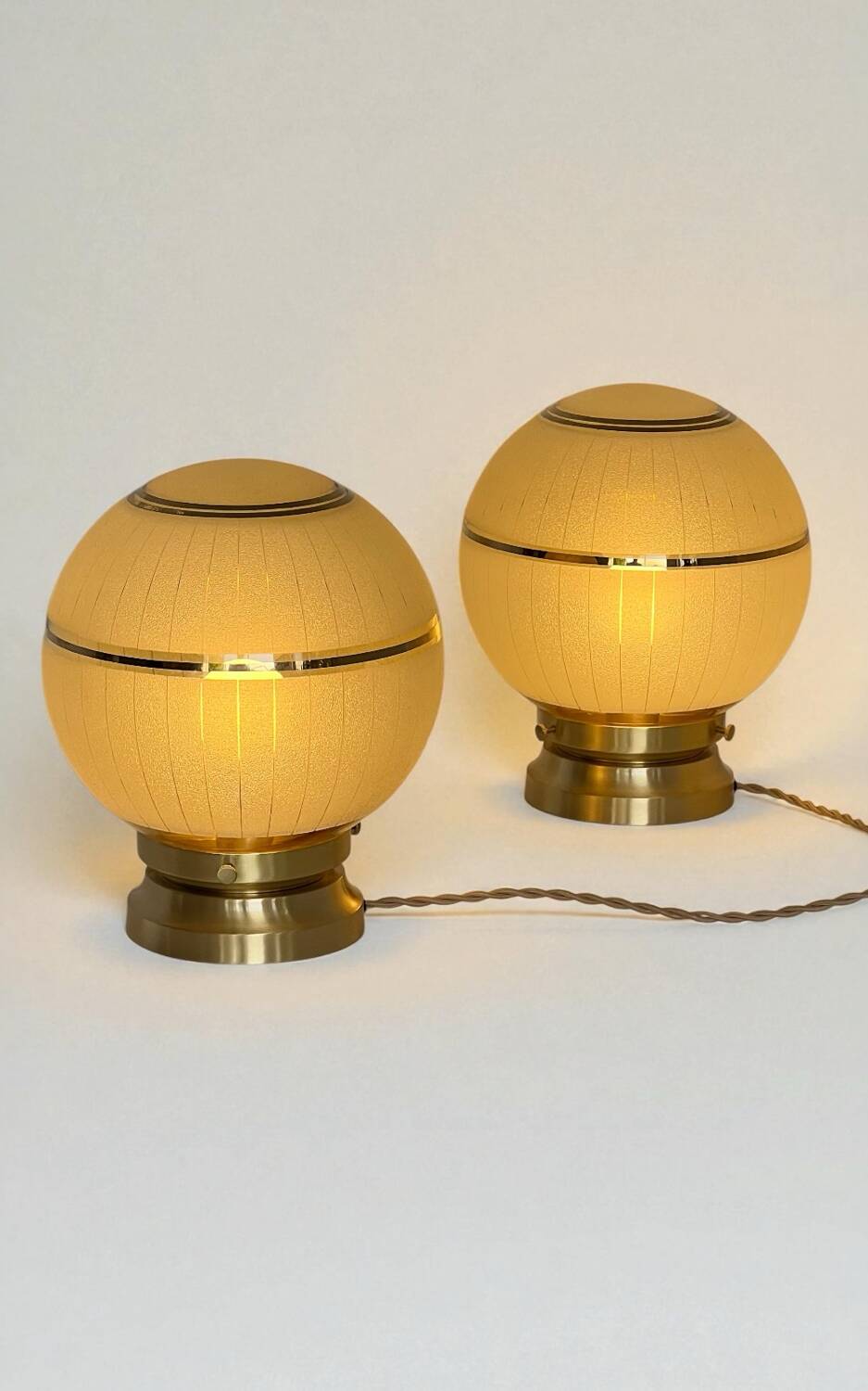 Pair of large art deco globe table lamps with brass legs