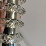Table lamp made of transparent crystal glass and silver colored spacers.