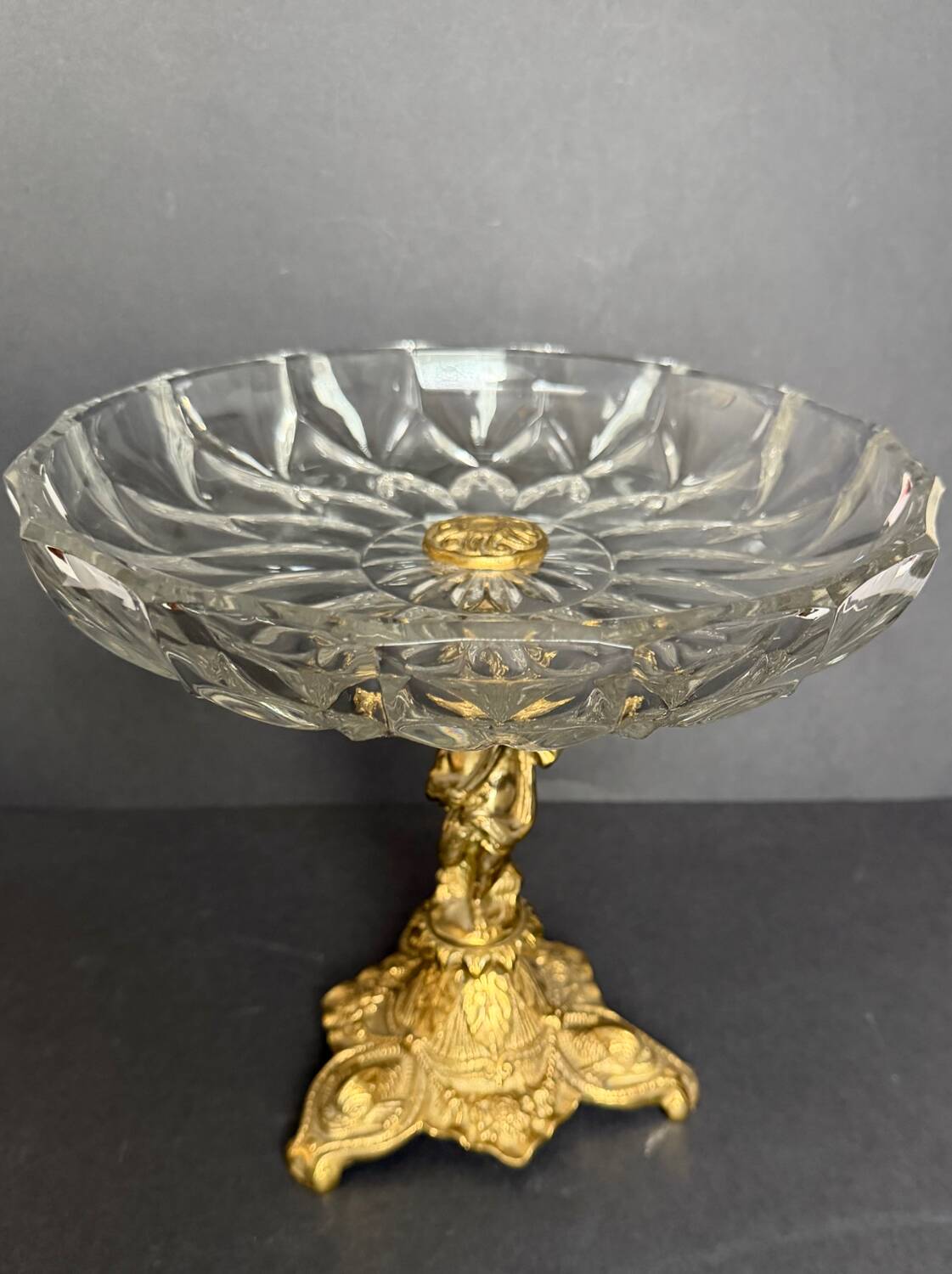 Antique crystal bowl on a bronze stand.
