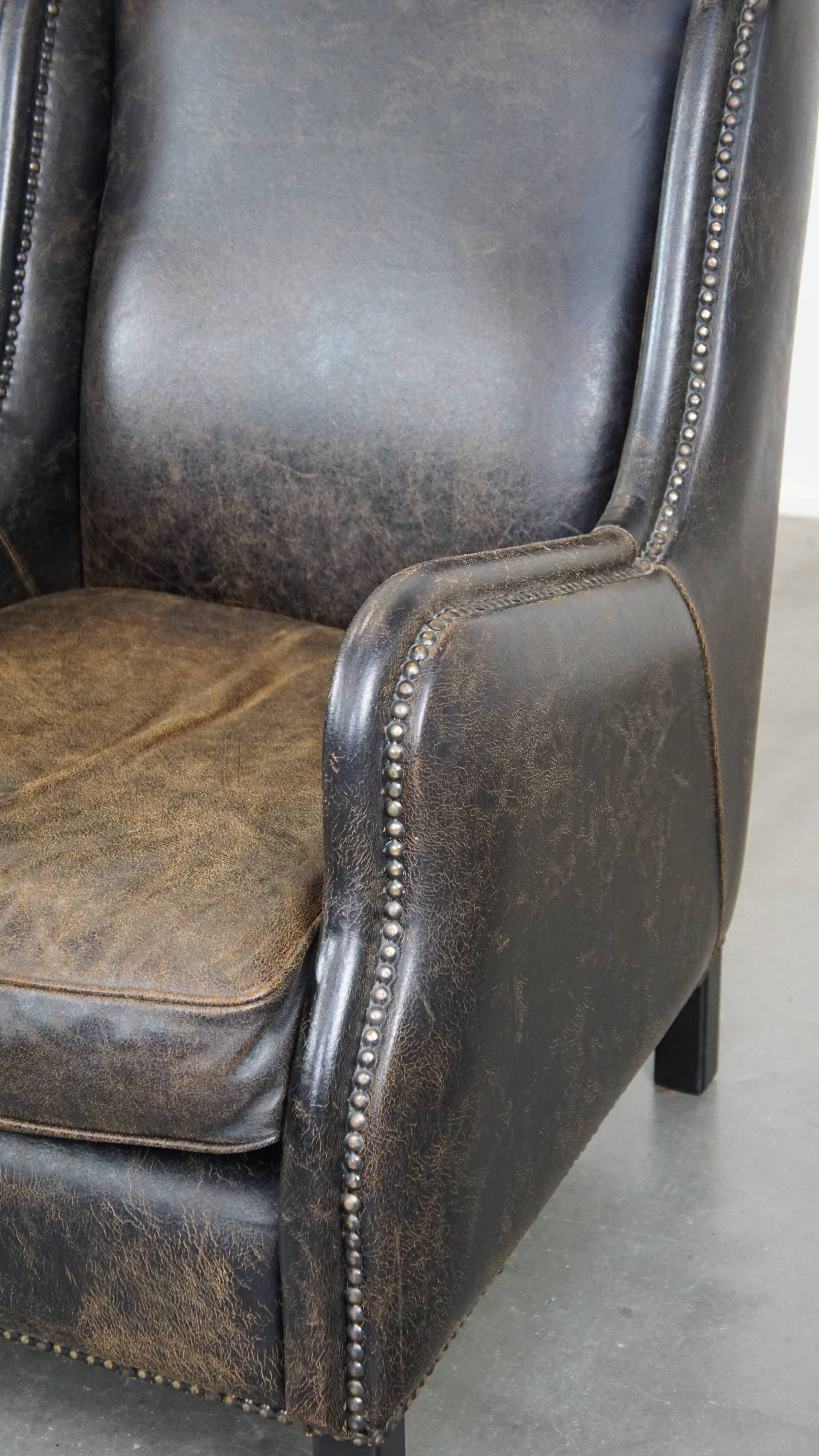 Set of 2 black cow leather armchairs finished with decorative nails, industrial style