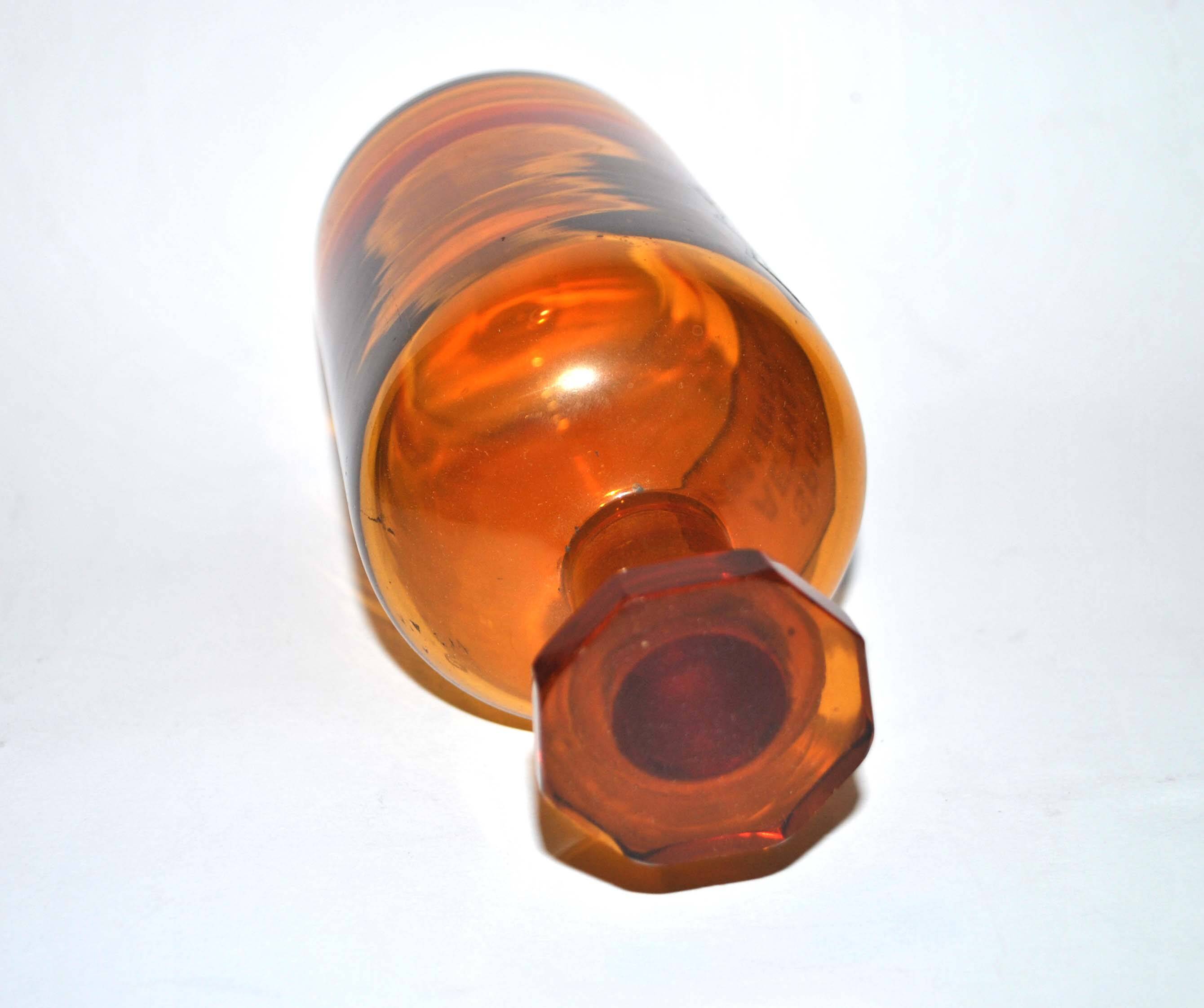 Old apothecary bottle Glass pharmacy bottle with enameled label