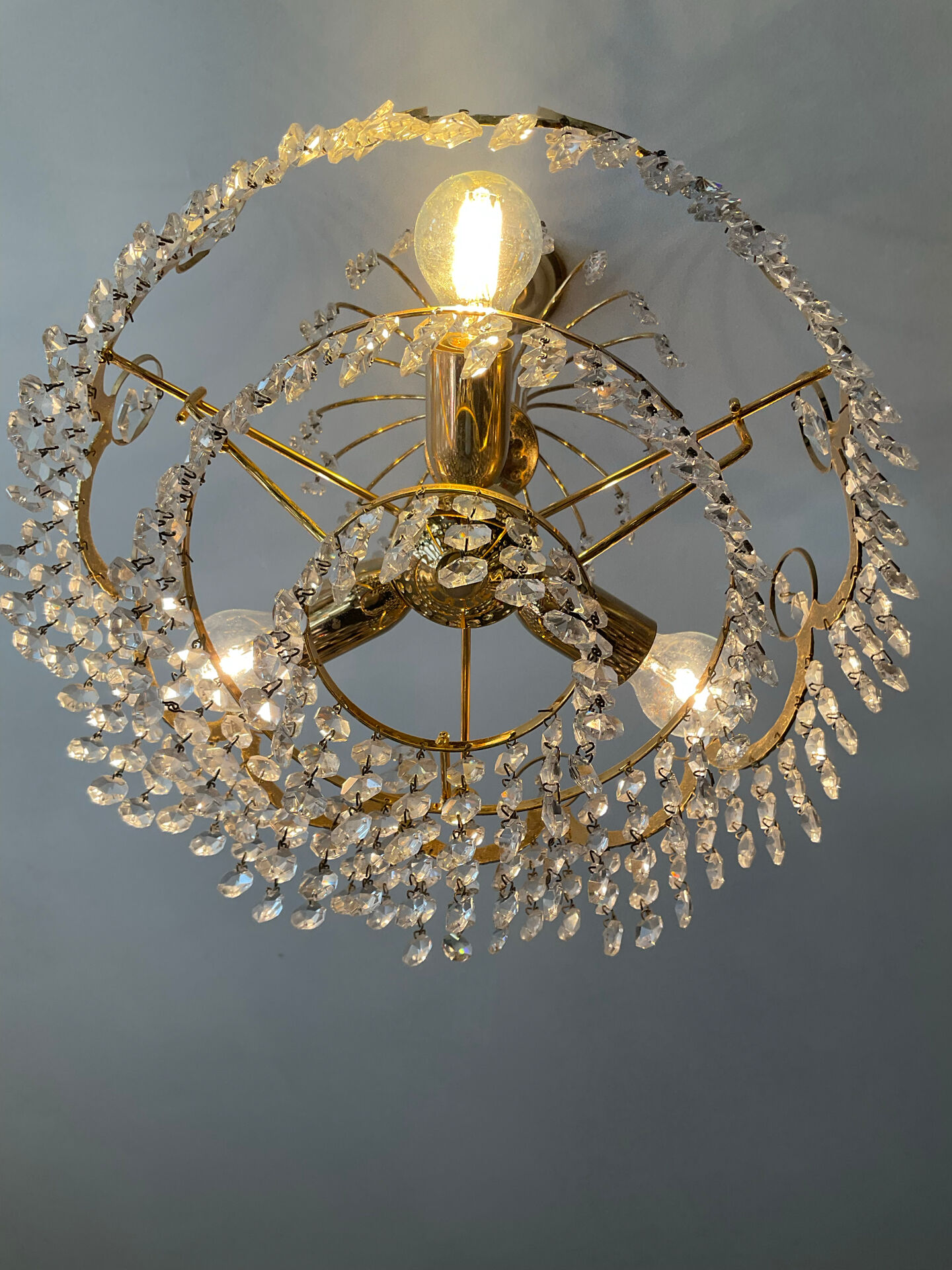 Brass chandelier with crystal pendants from the 1970s.