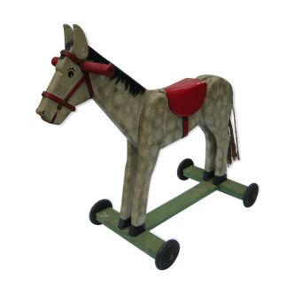 old wooden horse has wheels