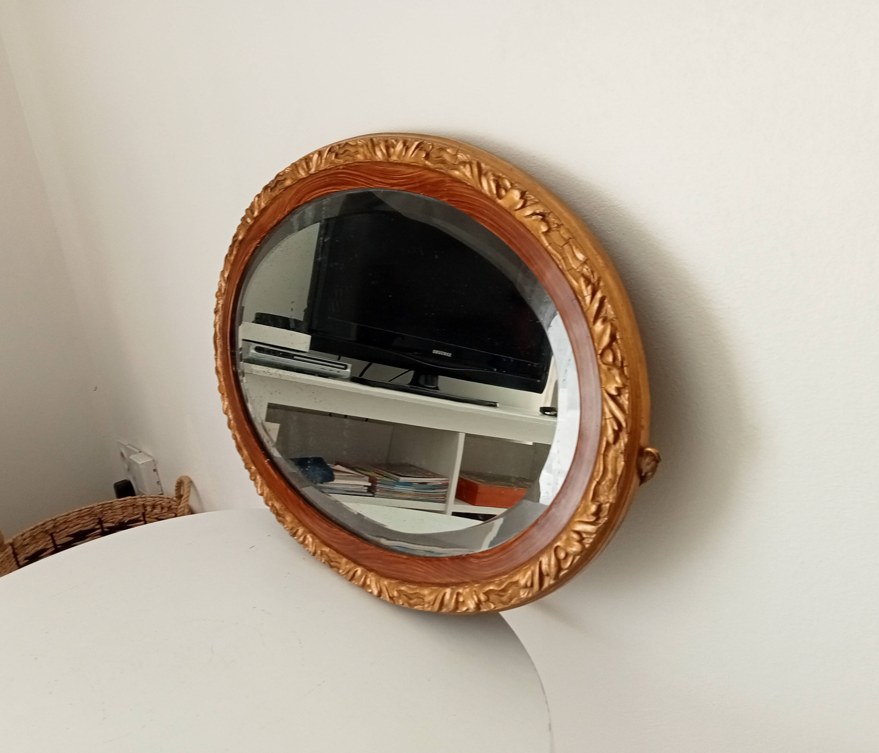 Antique oval mirror with beveled glass in wood and stucco, 19th century