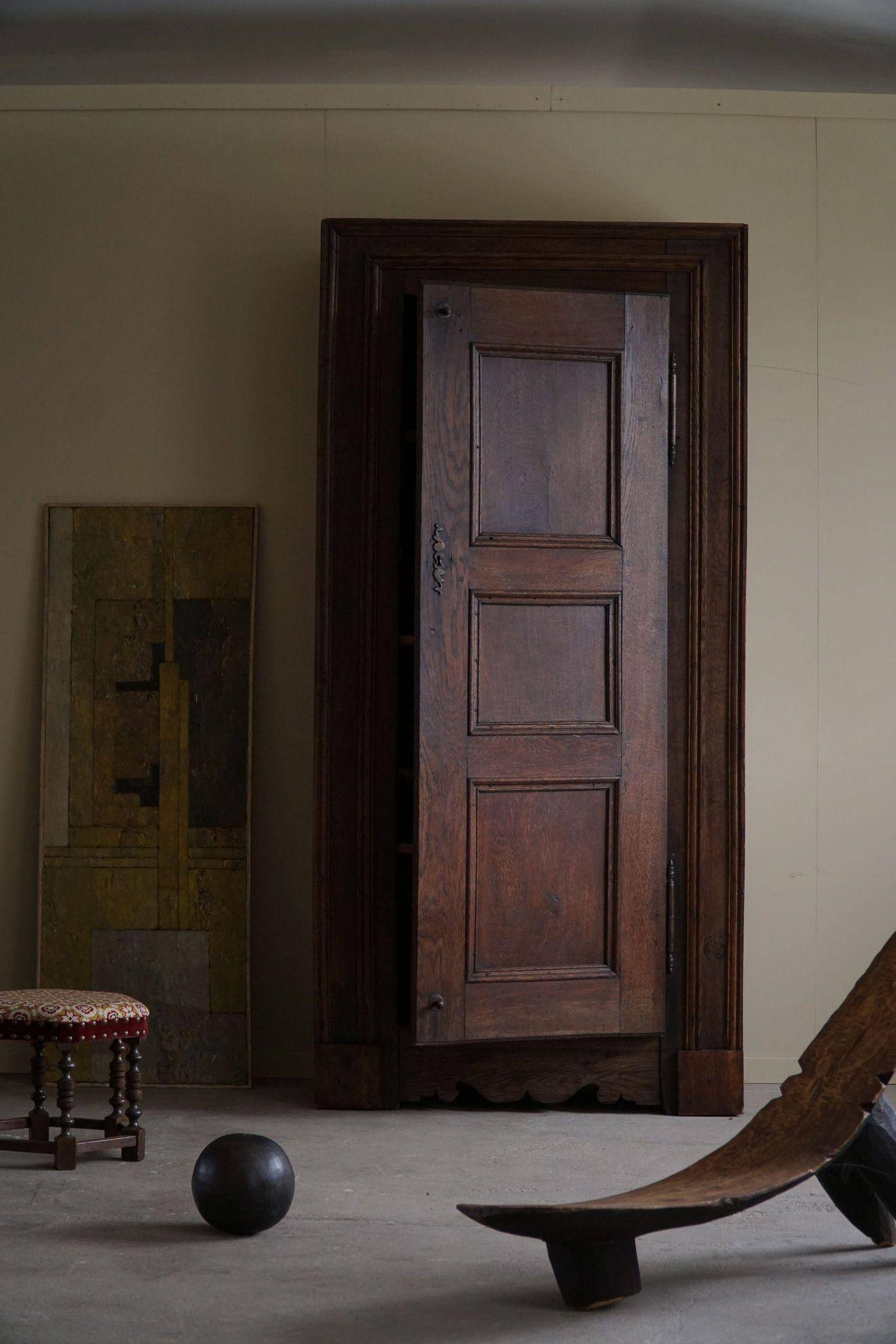 Tall antique oak wardrobe, made by a French cabinetmaker, late 19th century.