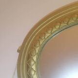 Oval mirror in wood and gilded plaster with pompom decoration