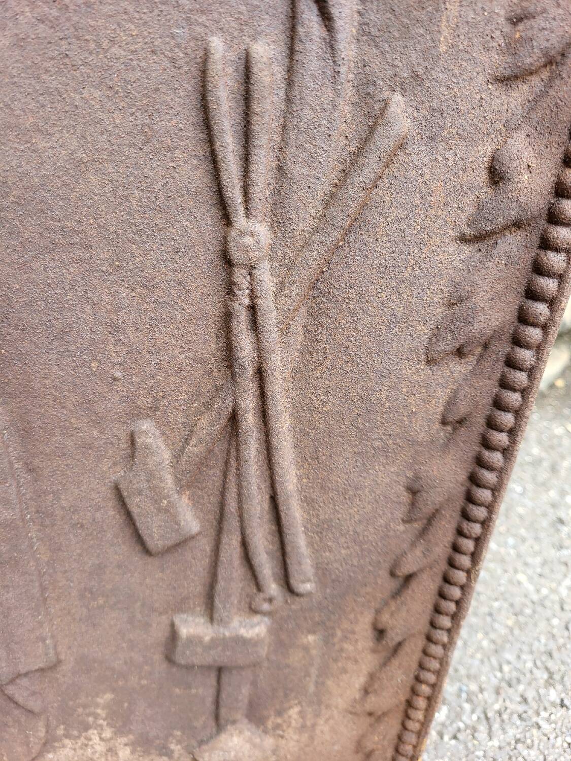 19th century cast iron fireback: bishop blessing the blacksmith's tools