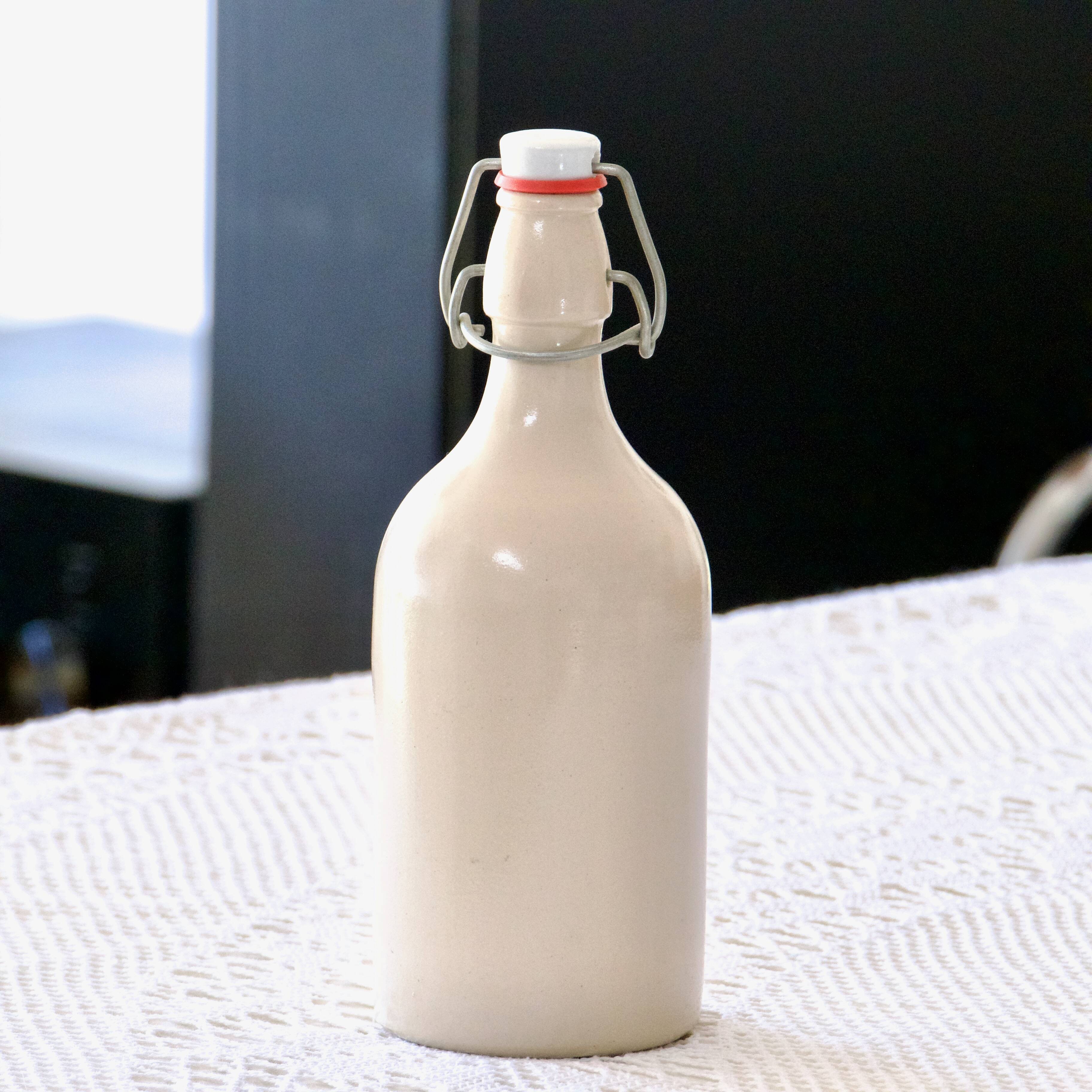 Antique enamelled stoneware beer bottle signed MKM