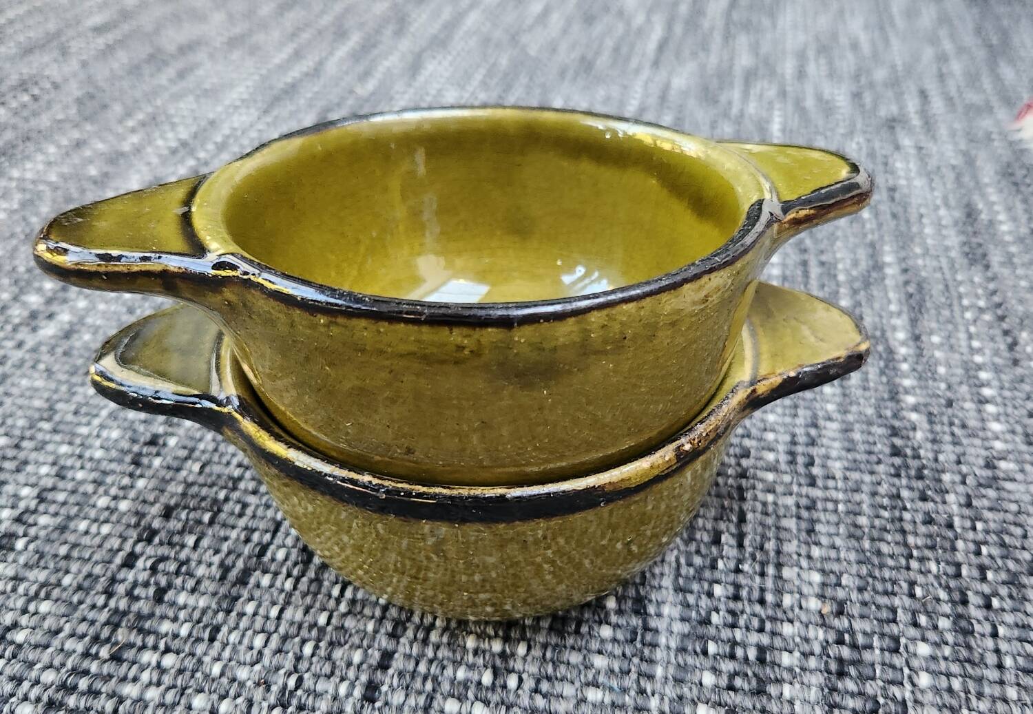 Set of 2 glazed khaki clay bowls.